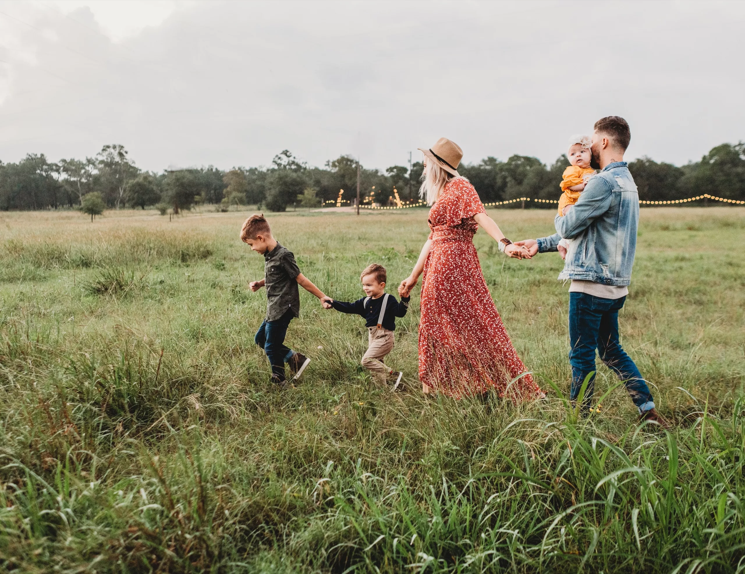 Family walking through a flowering meadow